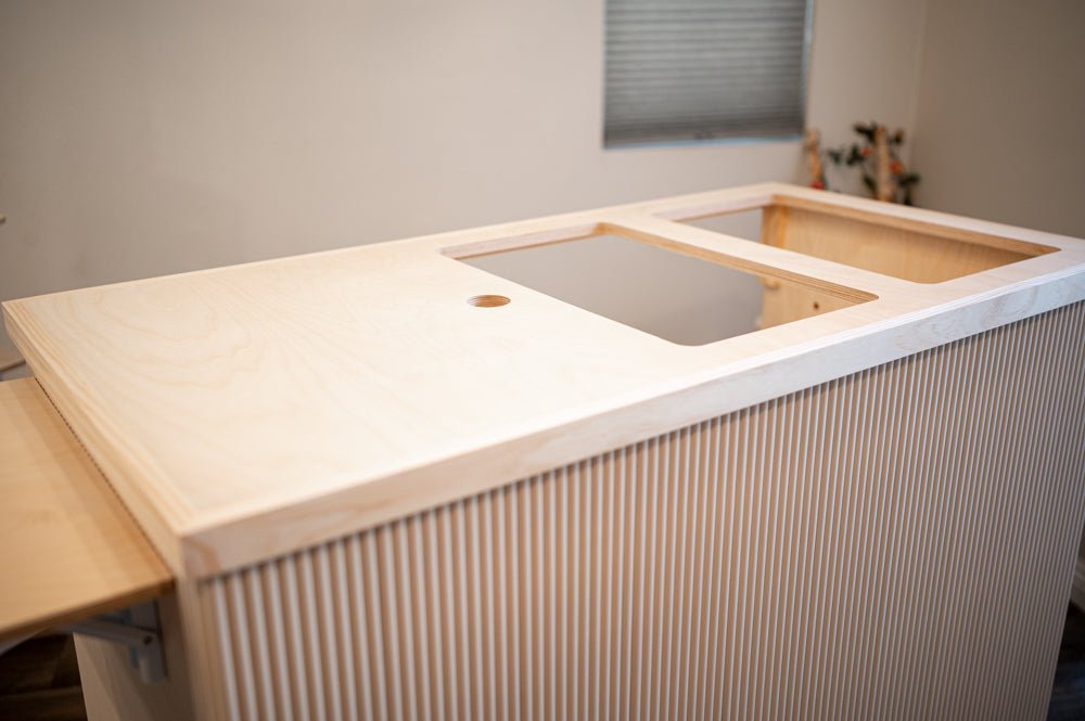 Mobile cart tabletop with inset cutouts and fluted side panels, on casters