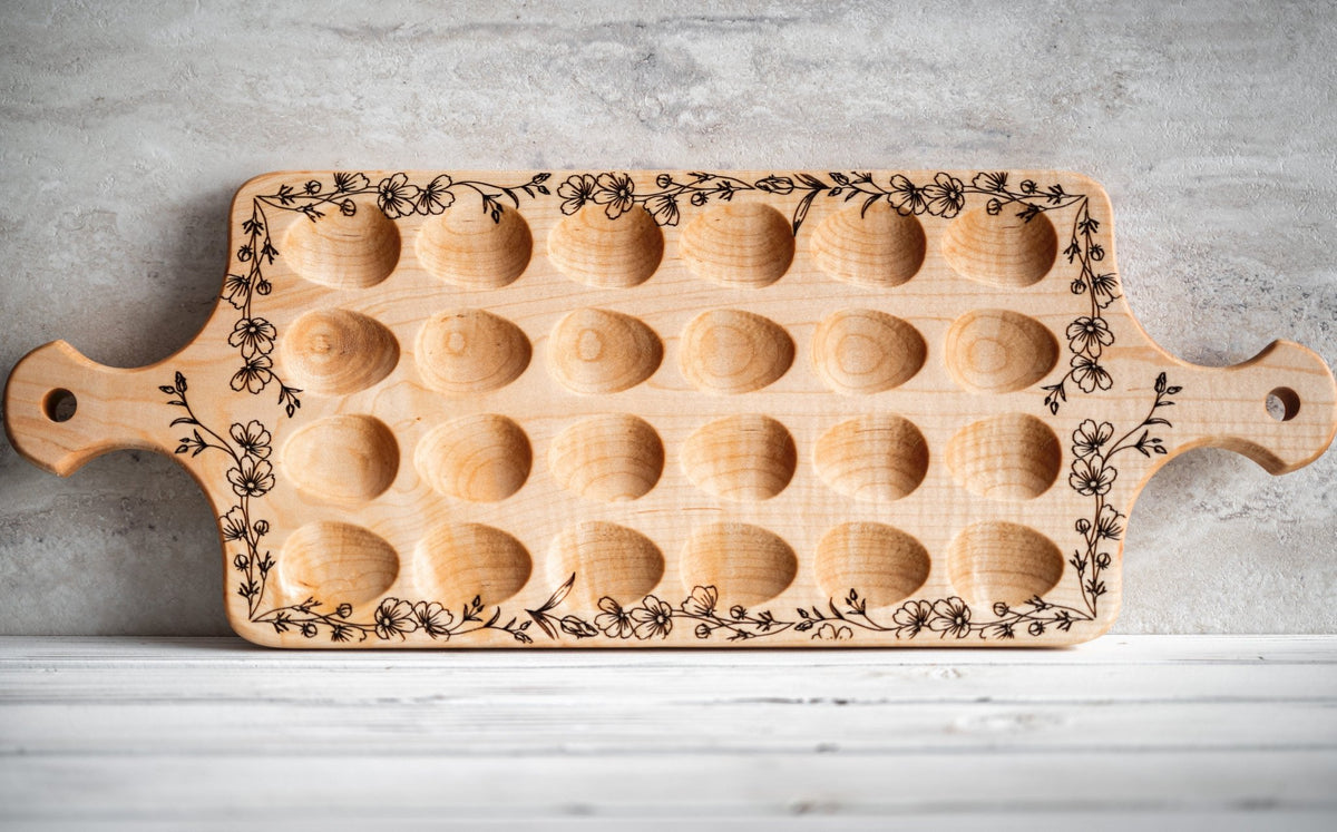 Light wood deviled egg serving tray with engraved border and empty round wells