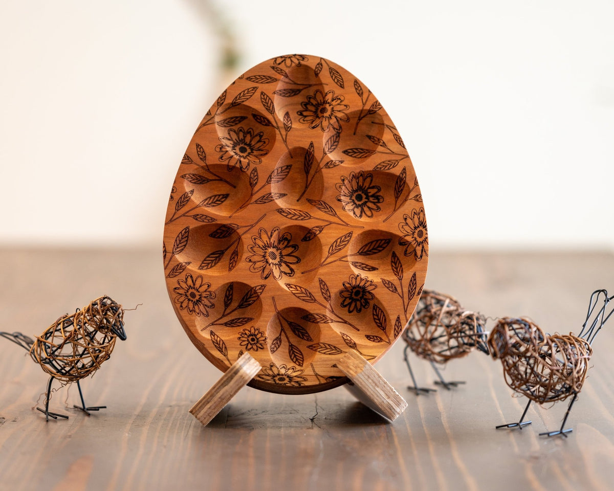 Wooden egg tray board with oval wells, dark floral engraving, and standing display