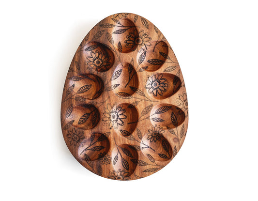 Wooden egg tray board with oval cutouts and dark engraved floral pattern