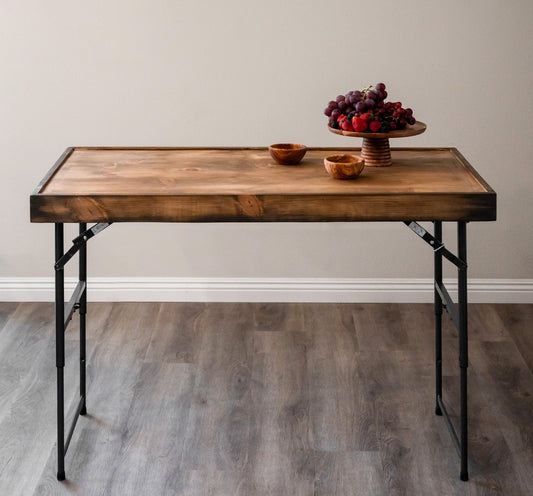 Wooden charcuterie serving board topper on folding table with small bowls centerpiece